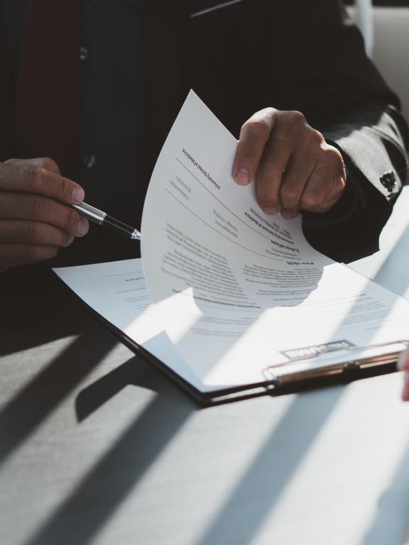 Executive reading a resume during a job interview