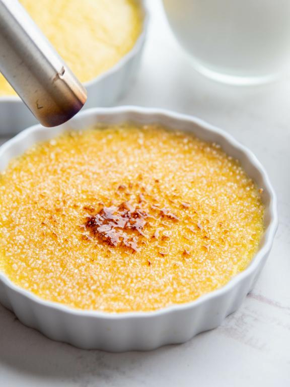 Créme brûlée with sugar being torched on top