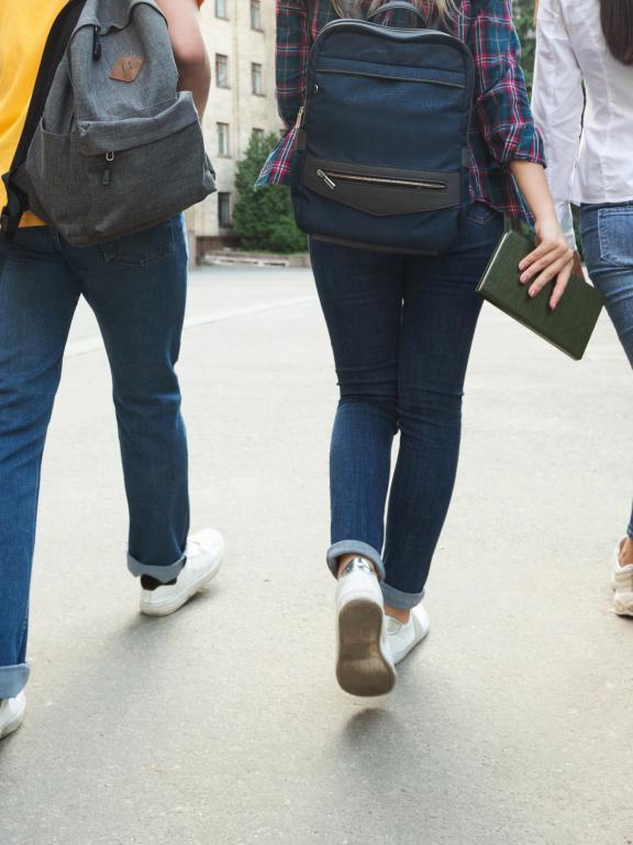 medium close up of student legs walking away