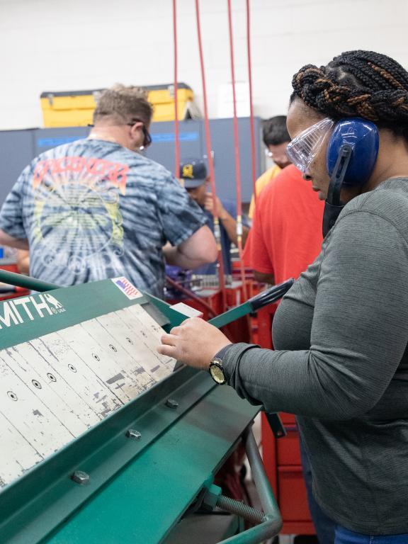 Woman works on Tensmith Press