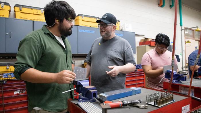 Instructor speaks with students in the Aviation Sheet Metal program