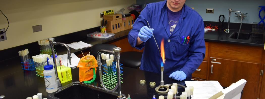 Science teacher does an experiment with high flame on burner