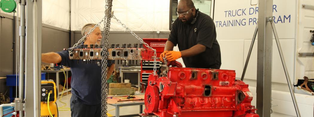 Diesel systems student works on parts in diesel garage