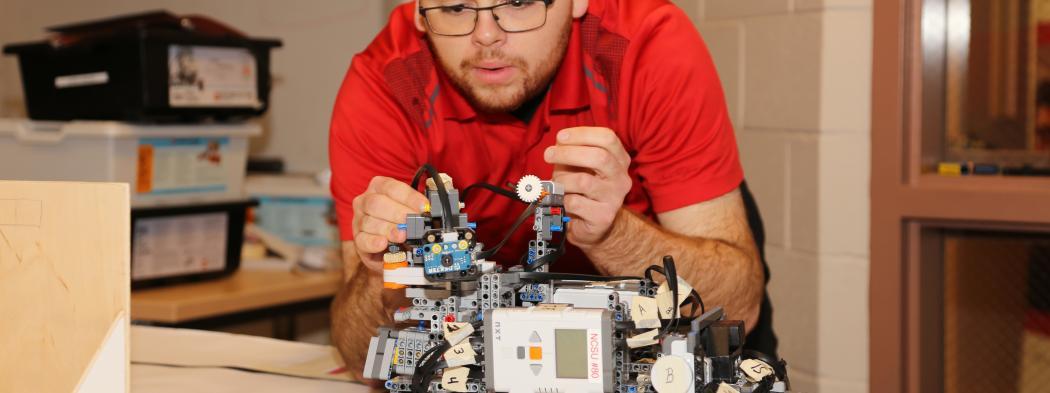 NC State Engineering program student tinkering with project