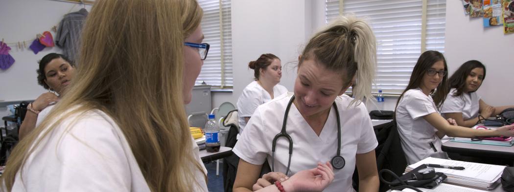 Nursing students practice taking heart rates