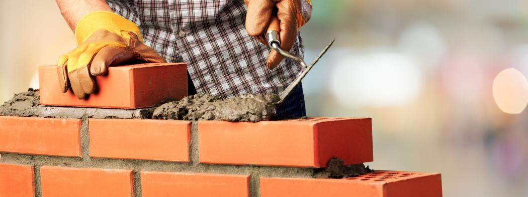 Mason lays a wall of bricks