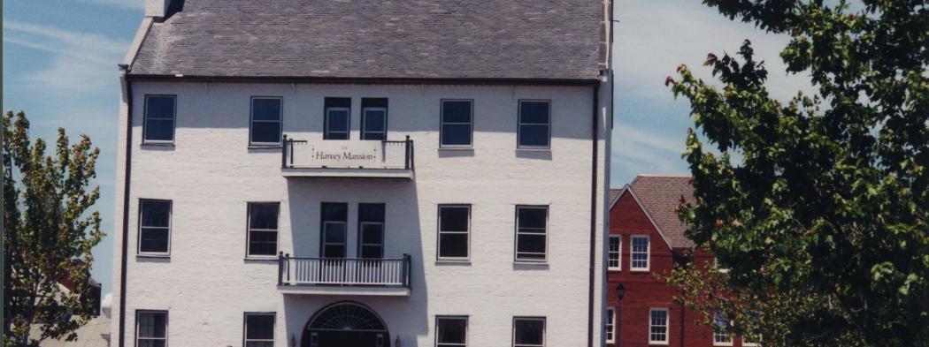 Exterior of white, three-story Harvey Mansion in 1980s or 1990s