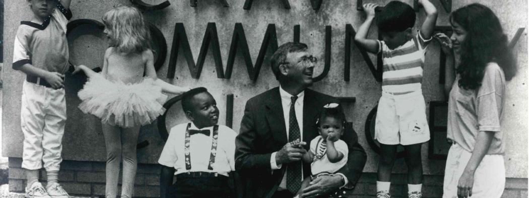 Dr. Steve Redd with children by Craven sign