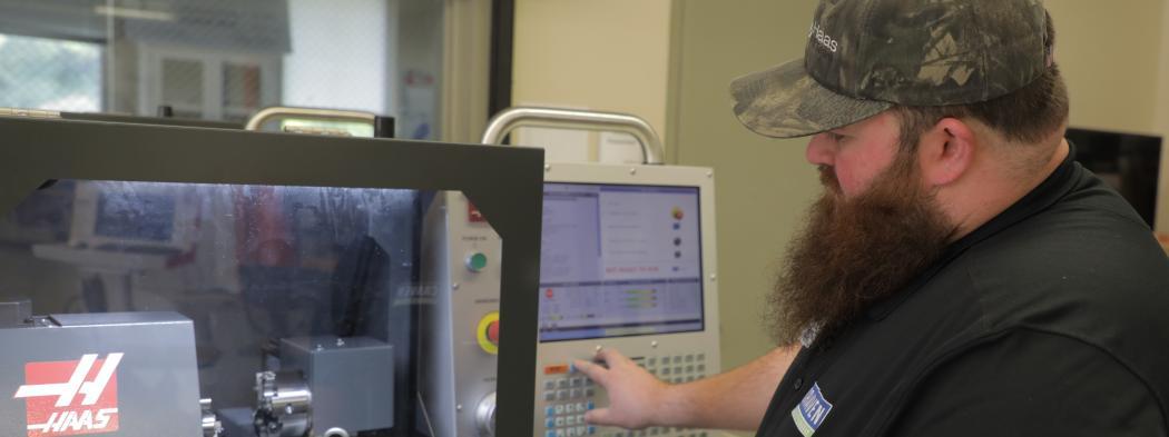 Computer-integrated machining instructor uses machine
