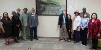 Craven Community College recently collaborated with the African American Heritage & Culture Center and the Craven Arts Council & Gallery to display a painting, “Chesapeake Bay Shad Fishers and Catch,” which was installed in the college’s Godwin Memorial Library on April 7. Pictured left to right are: AAHC and Craven CC Foundation board member Brenda George, AAHC Board President and Craven CC Foundation Board Member Carol Becton, Craven CC Foundation Board Emeritus and CACG Board President Linda MacDonald, A