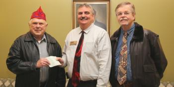 Charles Wethington (center), Craven CC’s executive director of institutional advancement, receives a donation from the Society of 40 & 8 members Bob Blair (left) and James T. Lewis. The funds will go toward a scholarship for students pursuing a degree in nursing. (Photo by Meredith Laskovics)