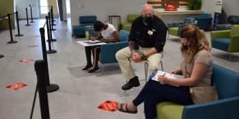 Bill Bondurant, Craven CC director of Advising & Counseling, assists students with registering for classes while following safety guidelines such as social distancing and wearing face coverings.