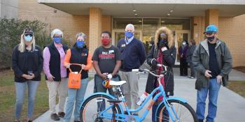 Student receives bike in front of Barker Hall