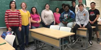 Craven Community College chemistry instructor Carmela Byrnes, left, poses with one of her chemistry classes. Byrnes has implemented a unique annual tradition in which her students are challenged to channel their inner creativity and come up with chemistry-themed lyrics to the tune of Christmas carols.