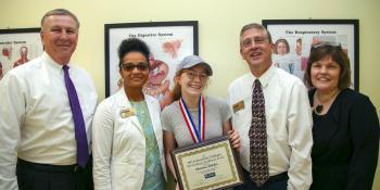 Craven CC student Christina “Ru” Fletcher receives a 2019 Academic Excellence Award. The North Carolina Community College System recognized one student from each of the state’s 58 community colleges. Pictured left to right are Jim Millard, Craven CC vice president for administration; Zomar Peter, Craven CC dean of enrollment management; Ru Fletcher; Dr. Ray Staats, Craven CC president; and Dr. Kathleen Gallman, Craven CC vice president for instruction.