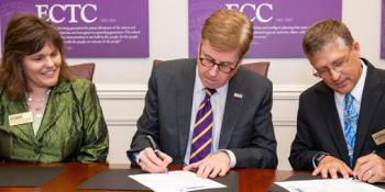 Dr. Kathleen Gallman, Craven CC vice president for instruction, looks on as ECU Chancellor Dr. Cecil Staton and Craven CC President Dr. Ray Staats sign a co-admission Agreement .