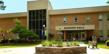 students walking outside Barker Hall by fountain