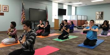 Students on mats doing yoga