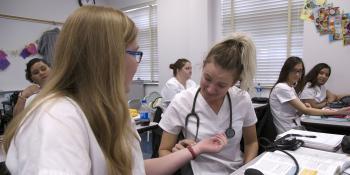 Nursing students practice taking heart rates