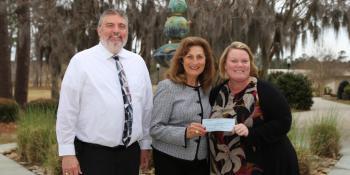New Bern Woman's Club member Brenda Harris (center) presents a check to Executive Director of Institutional Advancement Charles Wethington and Foundation Operations Coordinator Christina Bowman