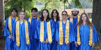 Group of 2025 student marshals in caps and gowns