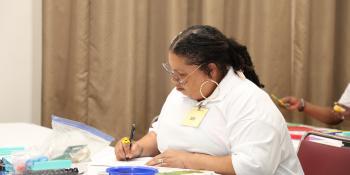 woman sits at a desk studying