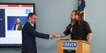 Two men shaking hands at Craven Podium