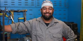 Man stands by welding device
