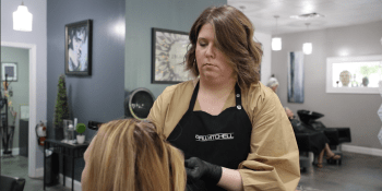 woman cutting and styling hair